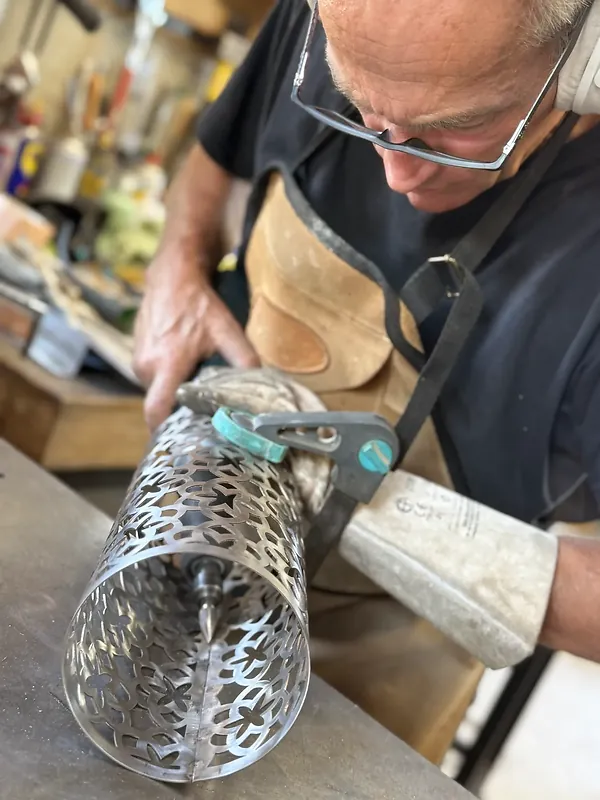 Façonnage à la main d'un luminaire en carton ajouré à l'atelier